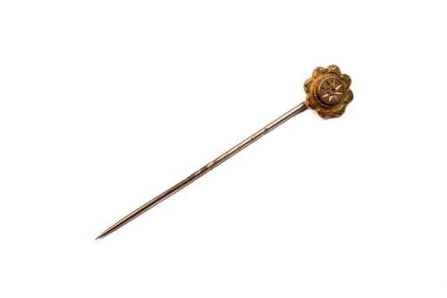 An antique diamond stick pin in 10 carat yellow gold