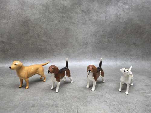 Four Beswick porcelain dog figures, including a Labrador and a basset hound, etc