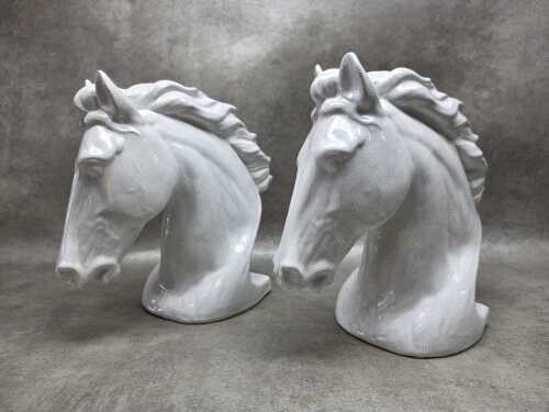 A pair of white ceramic horse heads