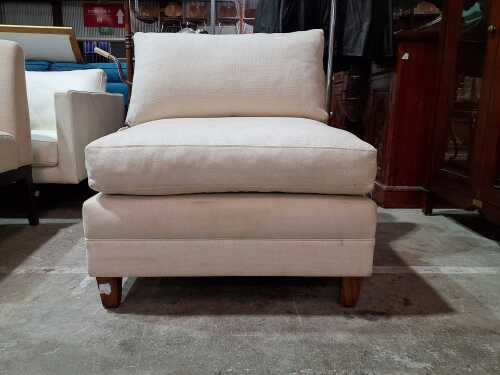 Cream fabric armless lounge chair