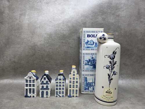 Four KLM Delft blue miniature canal houses and a Lucas Bols decanter