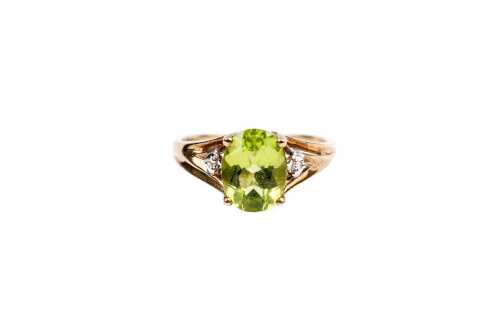 A peridot and diamond ring in 9 carat yellow gold