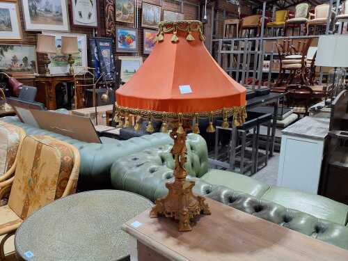 Gilded figural lamp table lamp with metal base and fabric tasselled shade