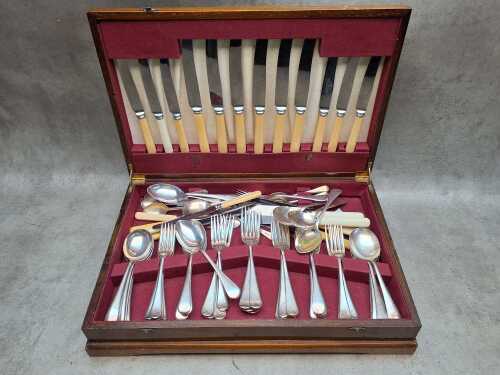 Assorted silver-plated cutlery in timber canteen