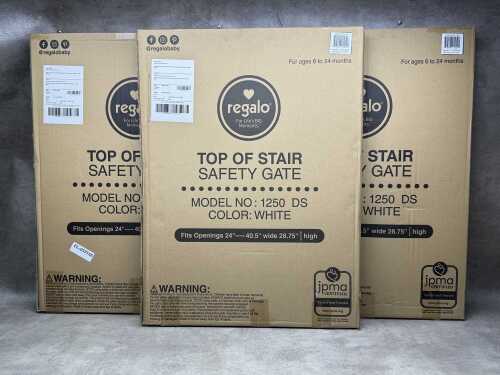 Three Regalo top of stair safety gates