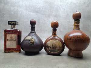 Disaronno Italian Liqueur, one bottle and three decorative empty bottles