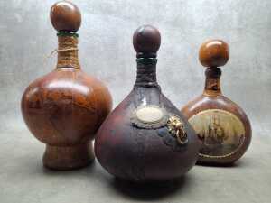 Disaronno Italian Liqueur, one bottle and three decorative empty bottles - 3