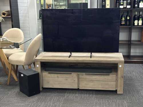 Samsung 55-inch OLED television with soundbar and subwoofer