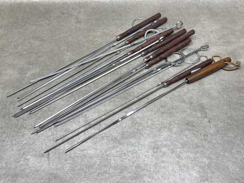 Catering-grade steel barbecue skewers with timber handles and ring loops