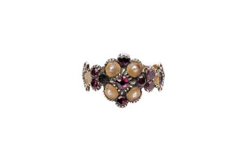 An antique garnet and pearl ring in 9 carat yellow gold