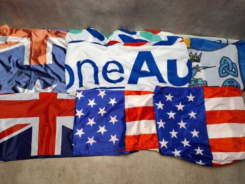 Collection of flags including the Australian National flag, USA, County Clare, etc