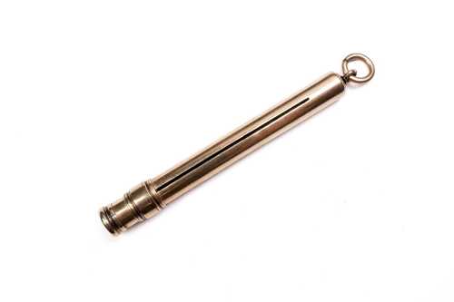 An outer section of a retractable pencil in 9 carat yellow gold