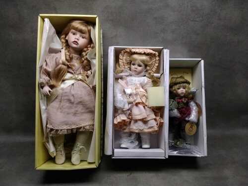Three porcelain dolls in original boxes