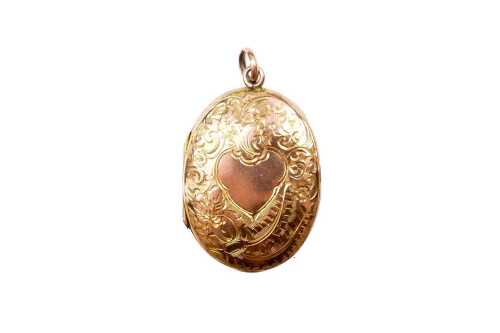 A vintage oval engraved locket with 9 carat yellow gold back and front