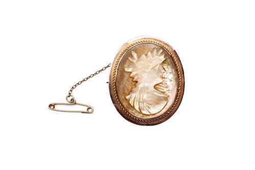 An antique mother of pearl cameo brooch in 9 carat rose gold