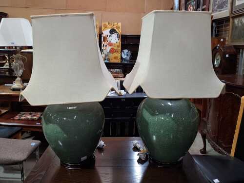 Pair of green porcelain base lamps with cream shade.