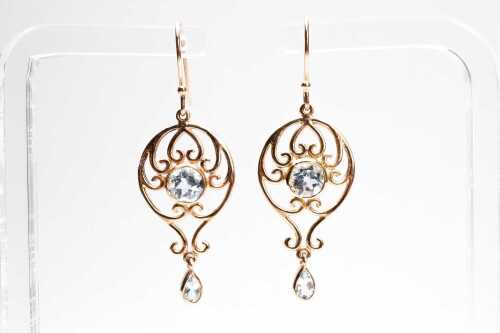 A pair of blue topaz drop earrings in 9 carat yellow gold.