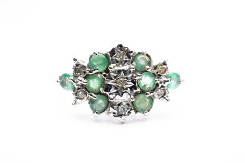 An emerald and diamond ring in 9 carat yellow gold.