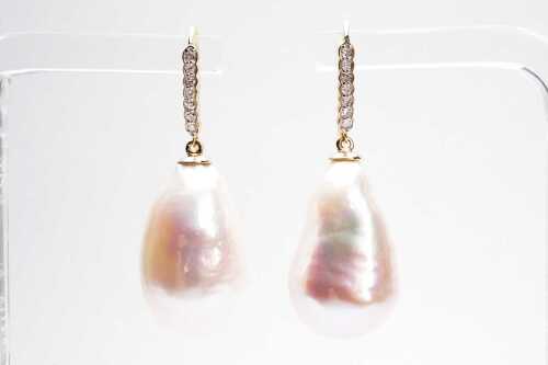 A pair of baroque pearl and diamond drops in 9 carat yellow gold.