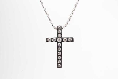 A diamond cross in 18 carat white gold with a 9 carat white gold necklace.