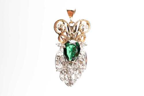 A diamond and dark green topaz pendant in 9ct yellow gold.