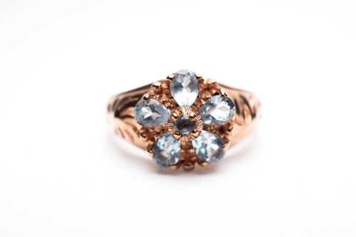 An aquamarine flower ring in 9 carat rose gold.