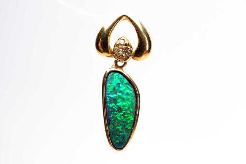 An opal doublet and diamond pendant in 18 carat yellow gold.