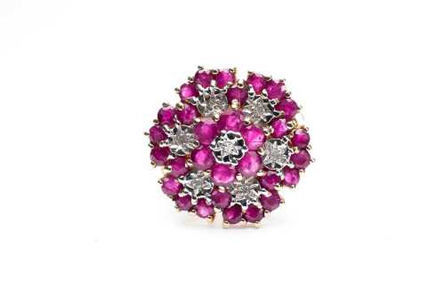 A ruby and diamond cluster ring in 9 carat yellow gold.
