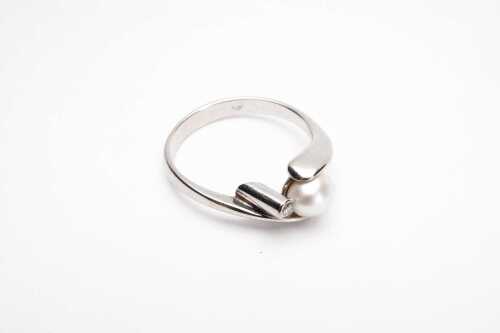 A pearl and diamond ring in 18 carat white gold.