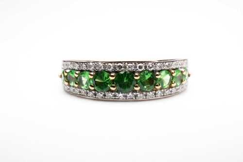 A peridot and diamond ring in 9 carat yellow gold.