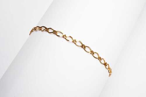 A one & one figaro link anklet in 9 carat yellow gold.