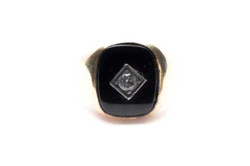 An onyx and white topaz signet ring in 9 carat yellow gold.
