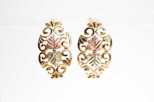 A pair of fancy drop earrings in 10 carat three tone gold.