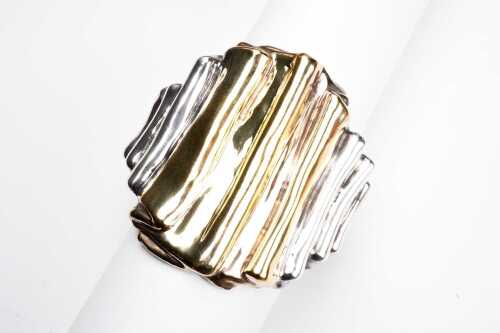 A vintage sculptural bangle in sterling silver and gold-plate