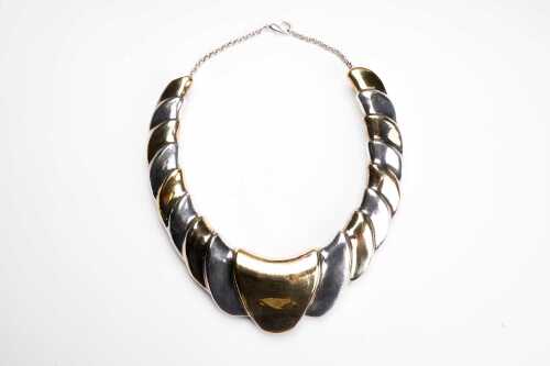 A vintage wavy torque in sterling silver and gold-plate