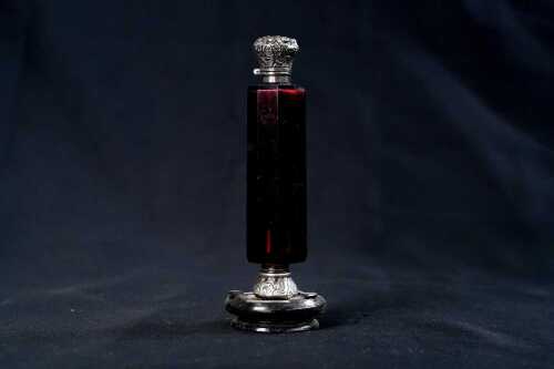 Victorian faceted ruby glass double ended scent bottle with silver mounted ends