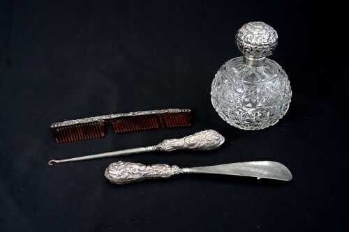 Four English sterling silver-mounted dressing table items