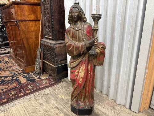 Antique European carved timber figural candle stand depicting a saint.
