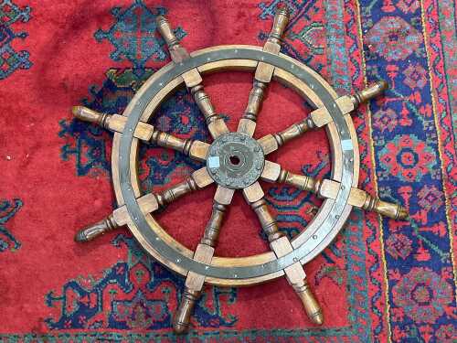 Timber ship's wheel with metal bindings