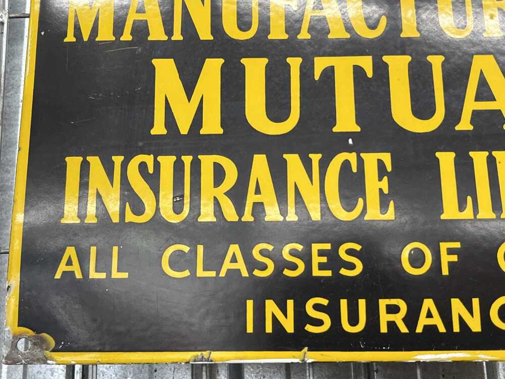 A vintage Manufacturers' Mutual Insurance Limited enamel sign.