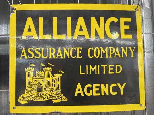 A vintage Alliance Assurance Company Limited yellow and black enamel sign.