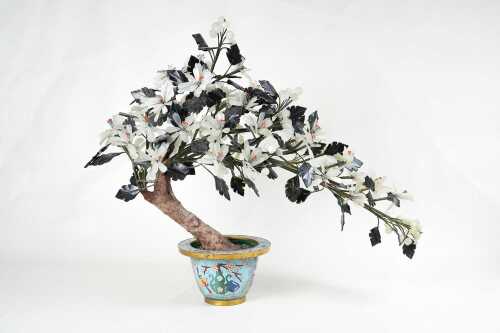 An Oriental carved stone bonsai tree in cloisonne pot