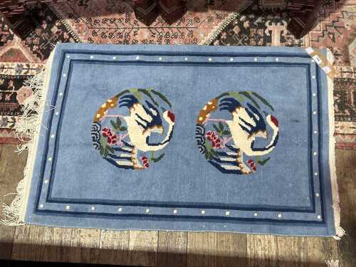 Oriental blue rug with two storks