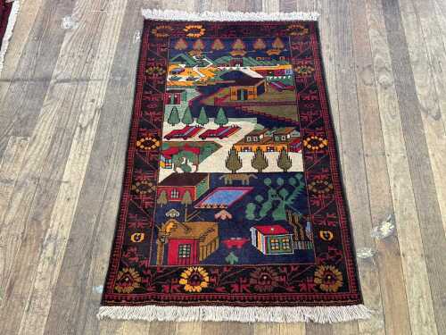 Handmade wool rug depicting streetscape with houses