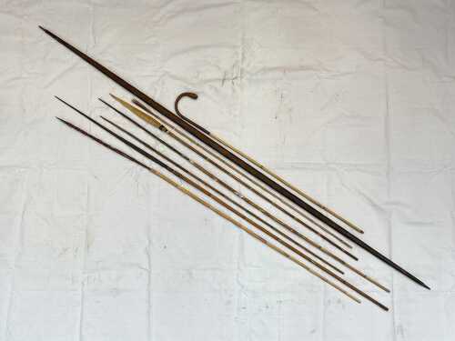 Group of traditional Oceanic hunting tools with decorative natural fibre bindings.