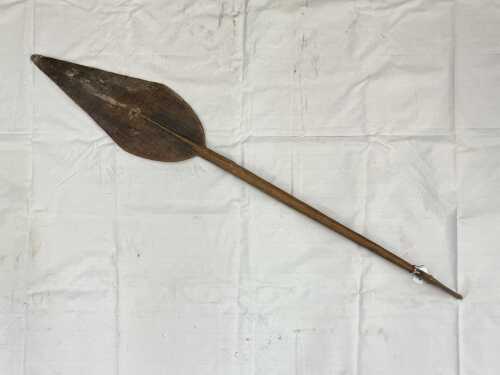 Traditional Papua New Guinea canoe paddle with stylised animal head handle.