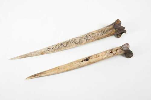 Two traditional Papua New Guinea carved cassowary bone daggers.