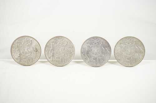 Four Australian round 50 cent coins