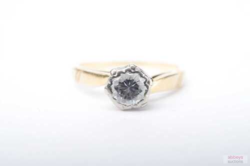 A diamond solitaire ring in 18ct yellow gold.