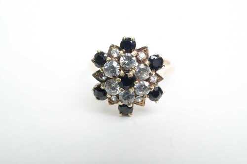 A sapphire and white paste cluster ring in 9ct yellow gold.